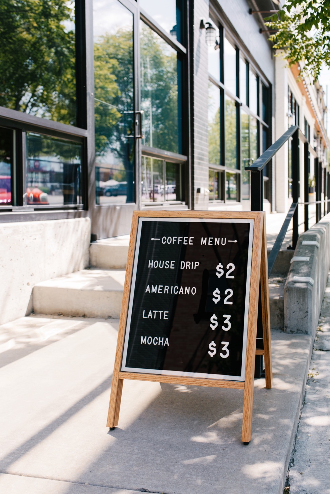 Coffee shop menu board on sidewalk